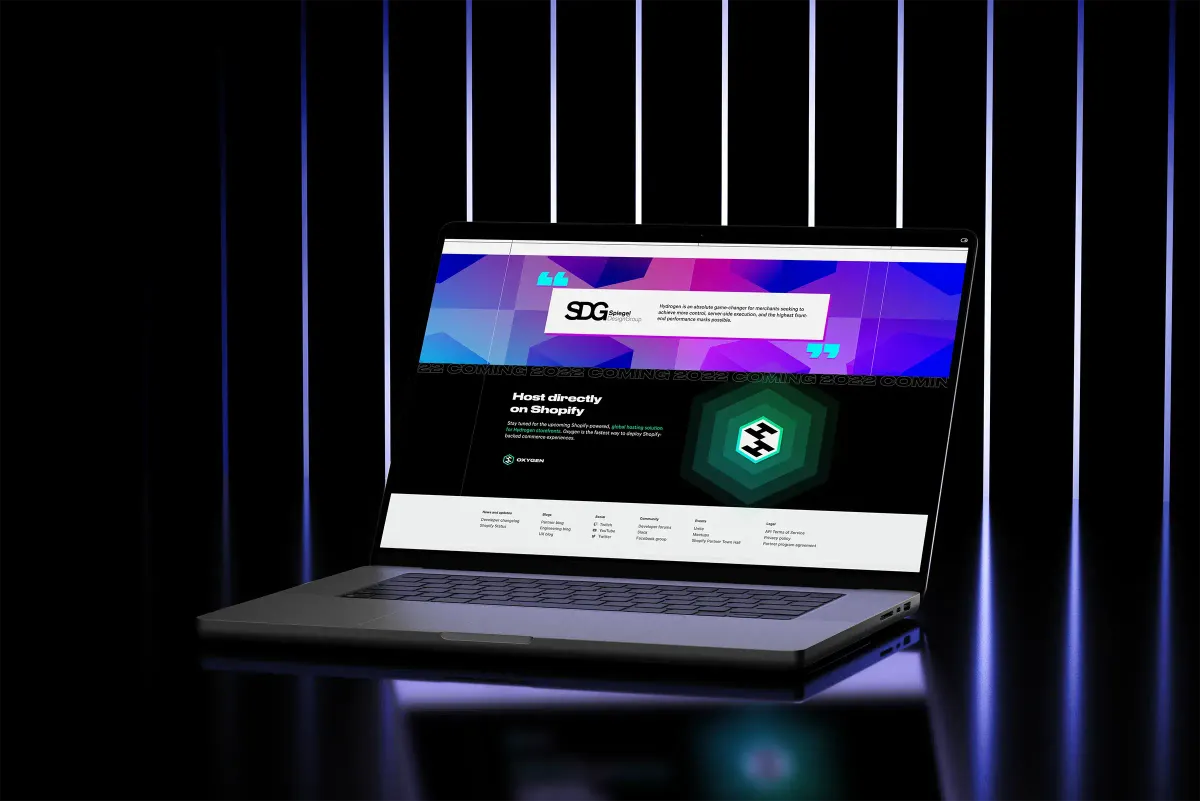 Laptop displaying a webpage with a testimonial from SDG (Shopify Developers Group) and a promotion for hosting directly on Shopify, set against a dark background with vertical blue light stripes.