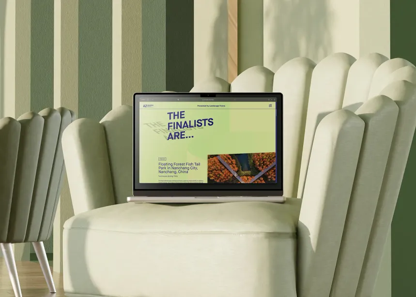 Laptop displaying a webpage titled 'The Finalists Are...' for the AZ Awards 2022, featuring a highlighted project called Floating Forest Fish Tail Park in Nanchang City, China, set on a soft green chair against a striped green background.